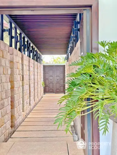 Elegant entrance with modern design and lush greenery