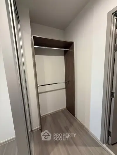 Spacious walk-in closet with modern design and ample storage space.