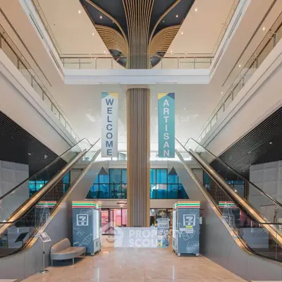 Stunning modern building entrance with escalators and elegant design, perfect for upscale commercial real estate.