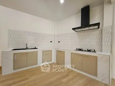 Modern kitchen with sleek cabinetry and gas stove in a stylish open layout.