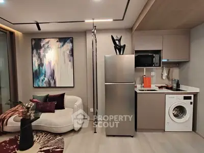 Modern living room with stylish decor and integrated kitchen appliances