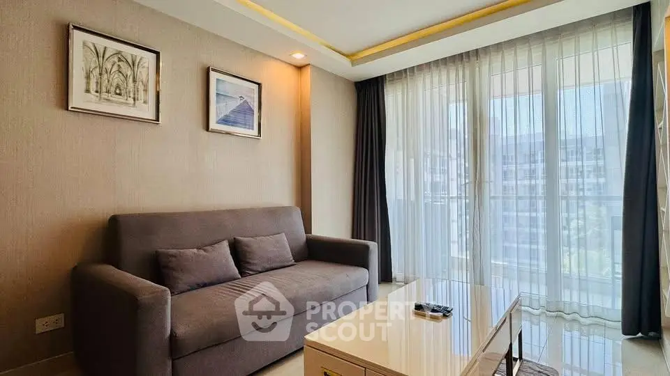 Modern living room with large windows and stylish decor in a high-rise apartment.