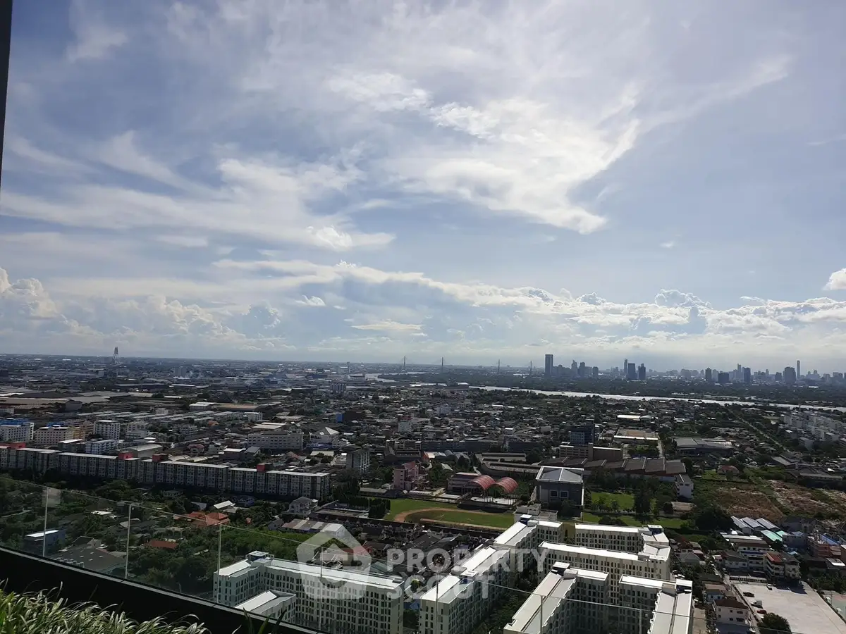 Stunning cityscape view from a high-rise balcony showcasing urban skyline and expansive horizon.