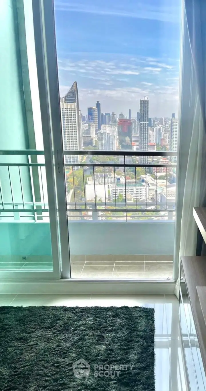 Stunning high-rise apartment with breathtaking city skyline view from the balcony.