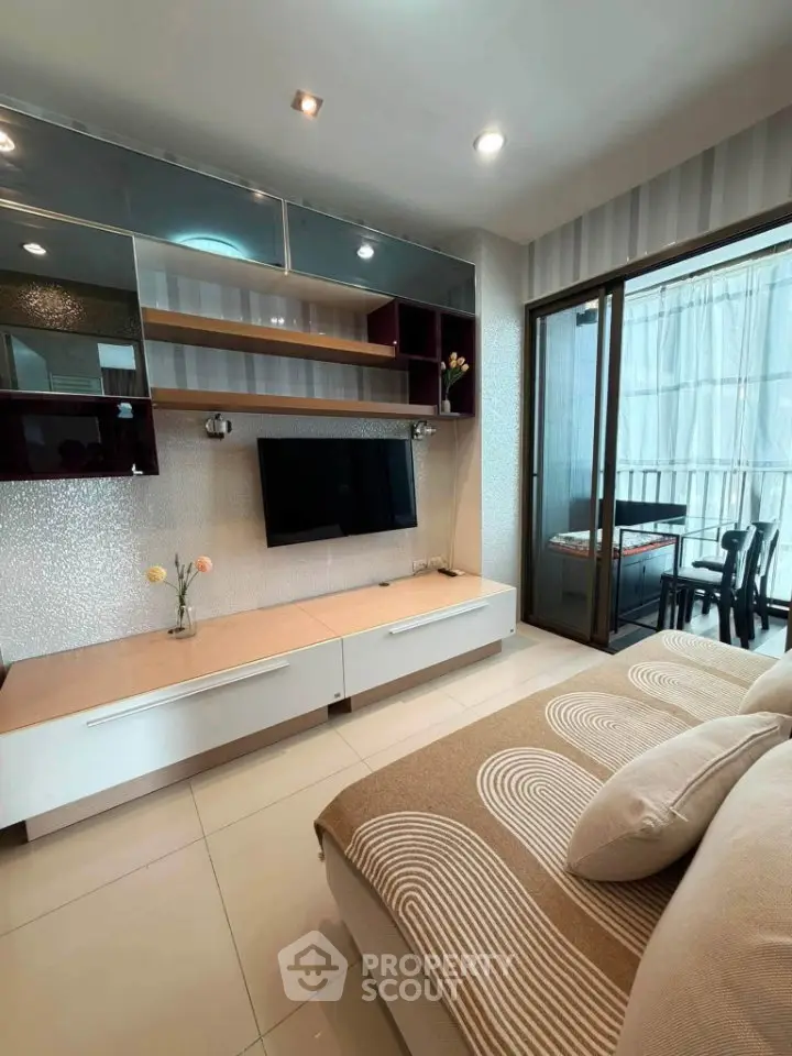 Modern living room with stylish decor and balcony access in a contemporary apartment.