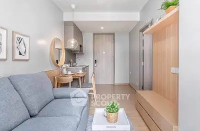 Modern living room with stylish decor and open kitchen layout in a cozy apartment.