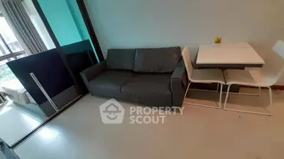 Modern living room with sleek sofa and dining area in stylish apartment