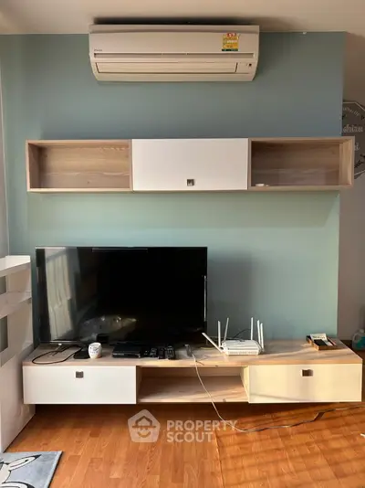 Modern living room with stylish TV stand and wall-mounted air conditioner