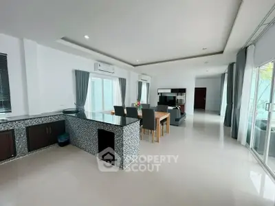 Spacious modern living room with open kitchen and elegant decor