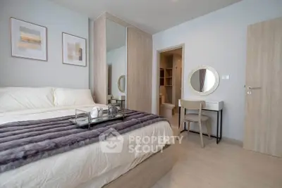 Modern bedroom with stylish decor and cozy ambiance, featuring a plush bed and elegant furnishings.