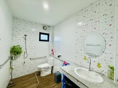 Spacious bathroom with modern fixtures and floral tile design.