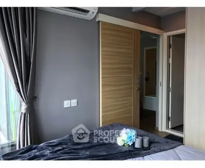 Modern bedroom with sleek design and soft lighting, featuring a cozy bed and stylish decor.