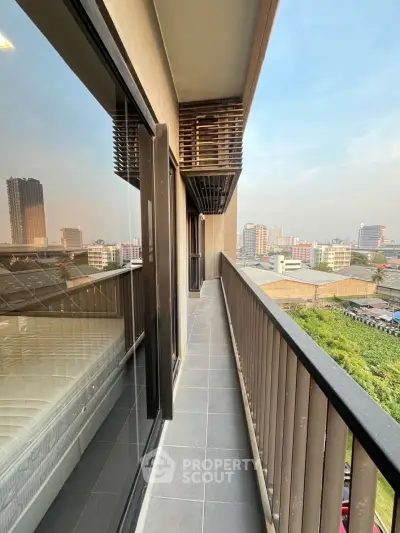 Spacious balcony with city view in modern apartment building