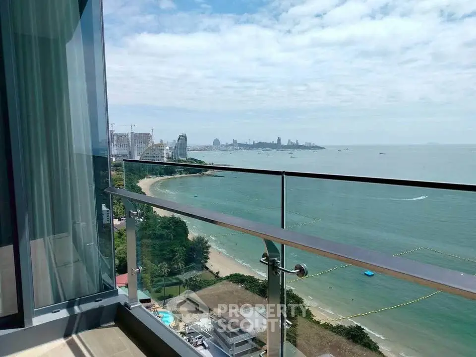 Stunning beachfront balcony view with panoramic ocean and city skyline.