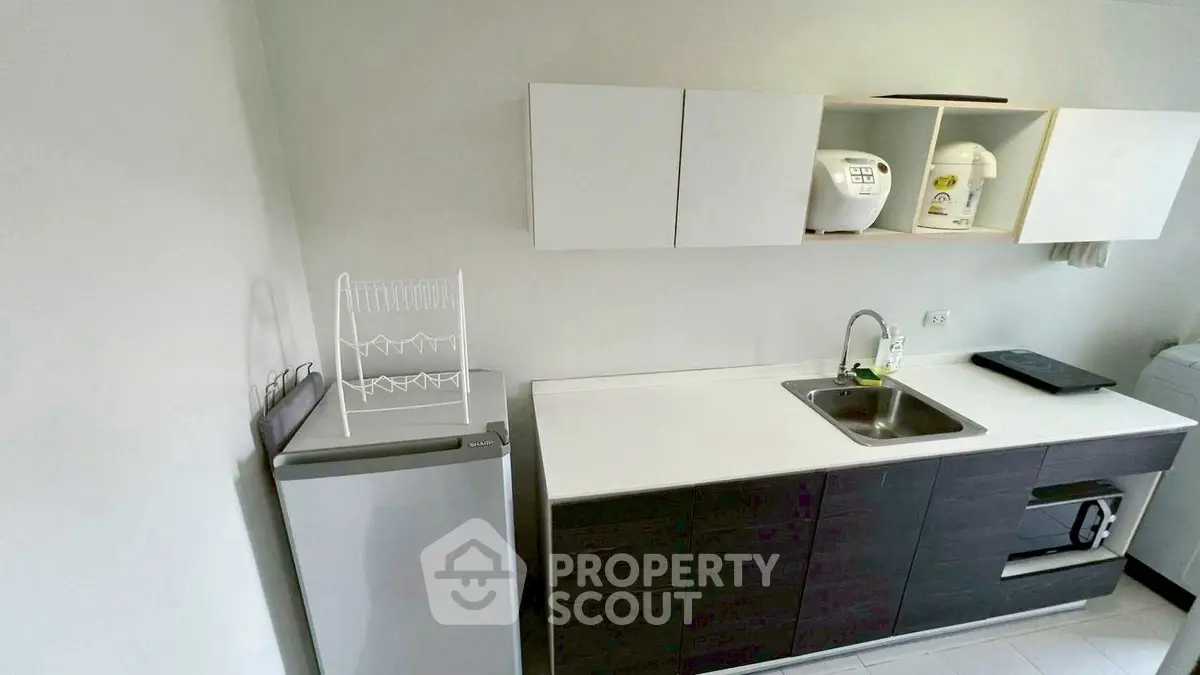 Modern kitchen with sleek cabinets and appliances in a compact layout