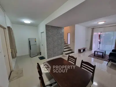 Spacious open-plan living and dining area with modern decor and natural light.