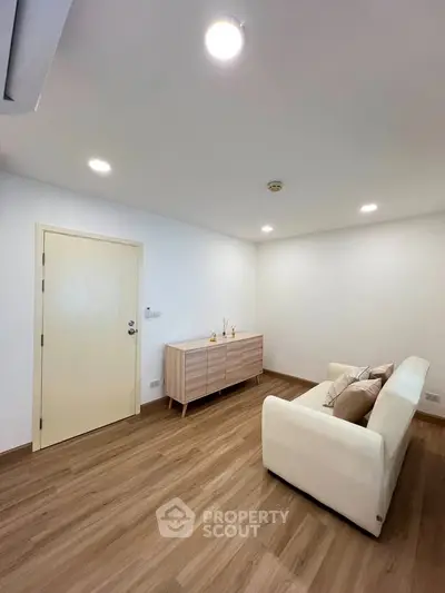 Modern living room with minimalist decor and wooden flooring