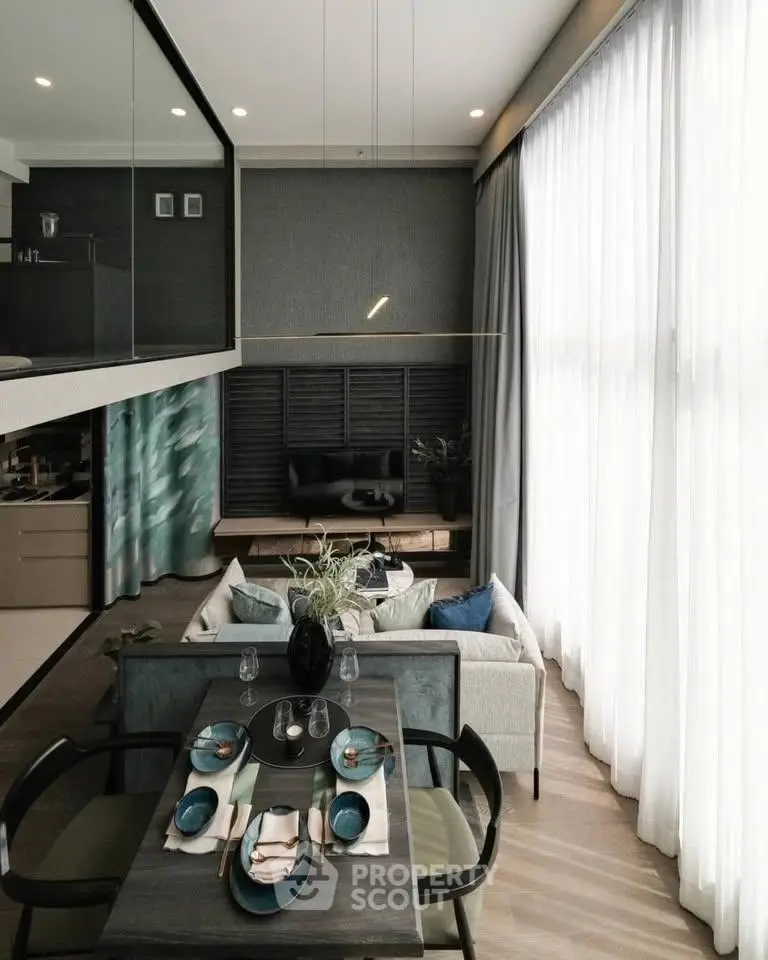 Modern living room with high ceilings and elegant dining area, featuring floor-to-ceiling windows and stylish decor.