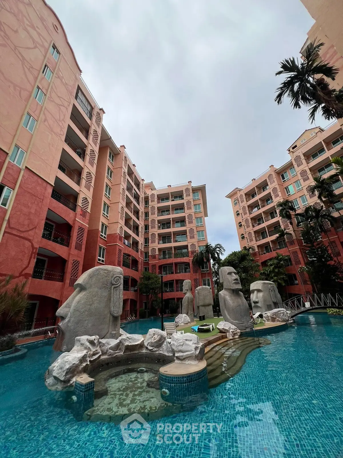 Stunning apartment complex with unique pool and statues, perfect for luxury living.