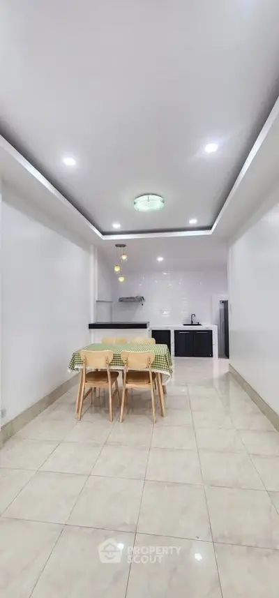 Spacious dining area with modern kitchen in open layout