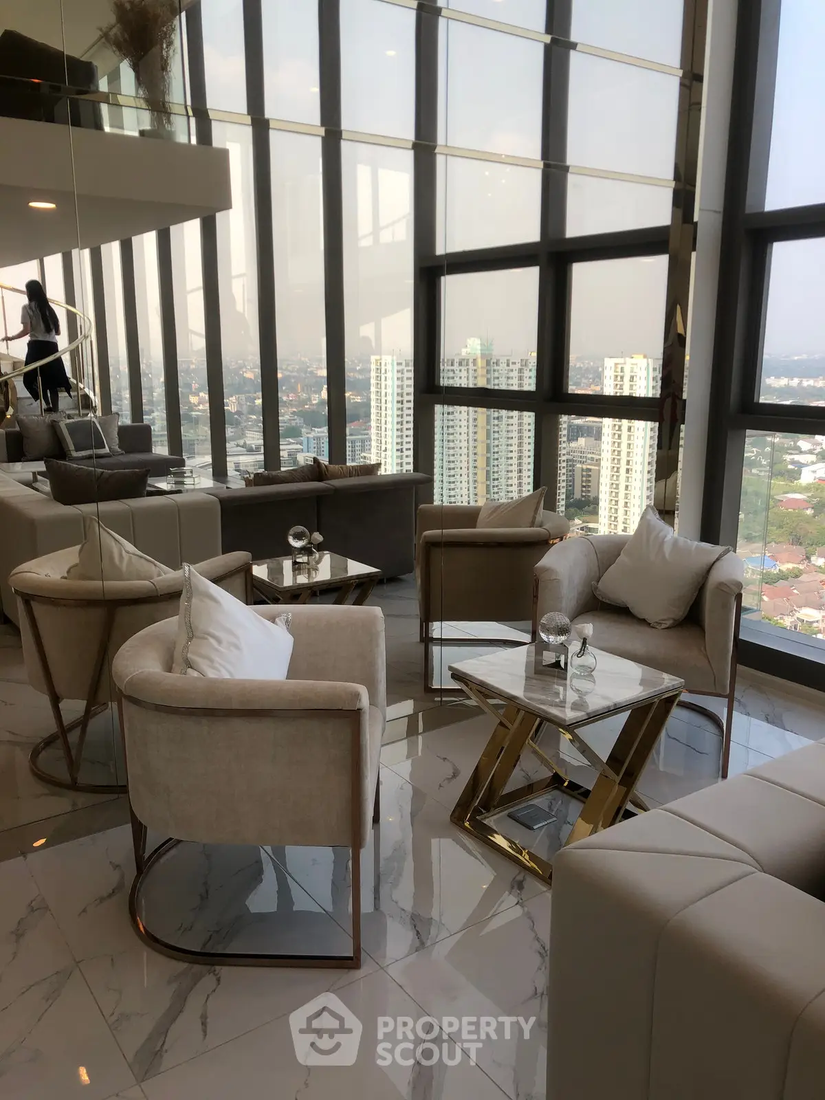 Luxurious high-rise living room with panoramic city views and elegant modern furniture.