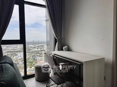 Modern study area with city view from high-rise apartment window.