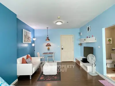 Charming living room with blue walls, modern furniture, and cozy dining area.