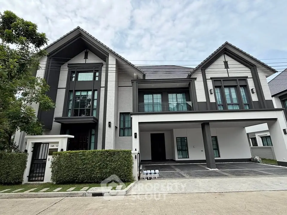 Stunning modern two-story house with sleek design and spacious driveway in a serene neighborhood.