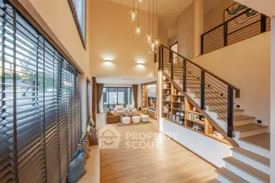 Luxurious modern living room with high ceilings and elegant staircase