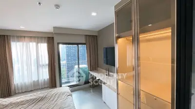 Modern bedroom with balcony view in a high-rise apartment