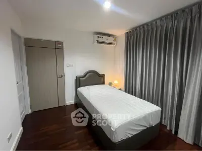 Cozy bedroom with single bed and elegant curtains in modern apartment