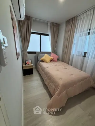 Cozy bedroom with soft lighting and elegant curtains, perfect for relaxation.