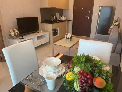 Modern living room with dining area, stylish decor, and open kitchen layout in a cozy apartment.