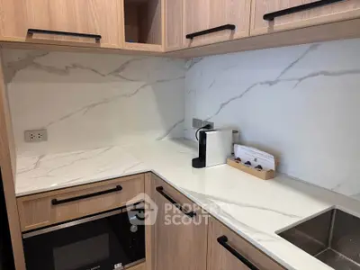 Modern kitchen with sleek marble countertops and built-in appliances