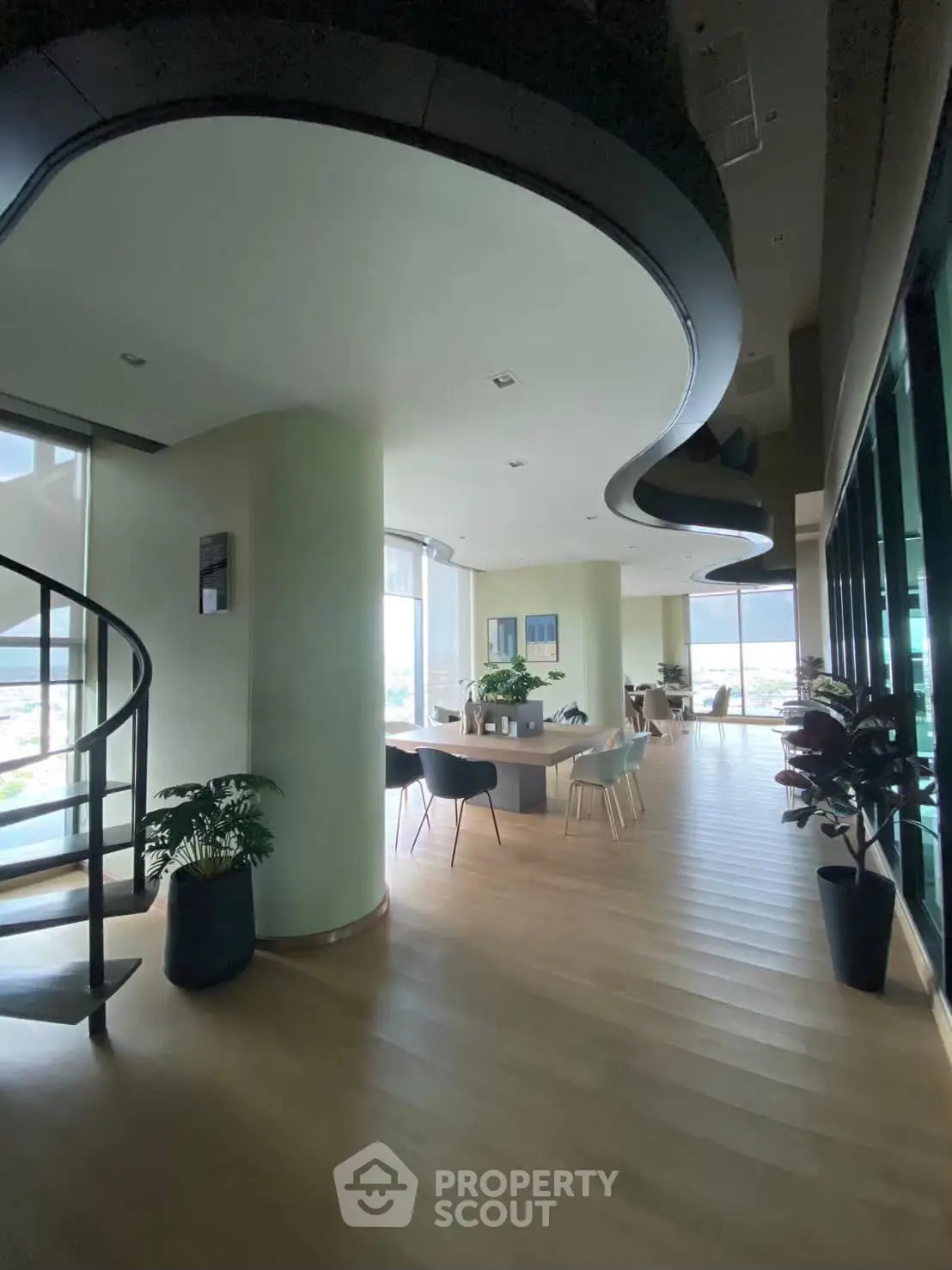 Spacious modern living room with unique ceiling design and panoramic windows