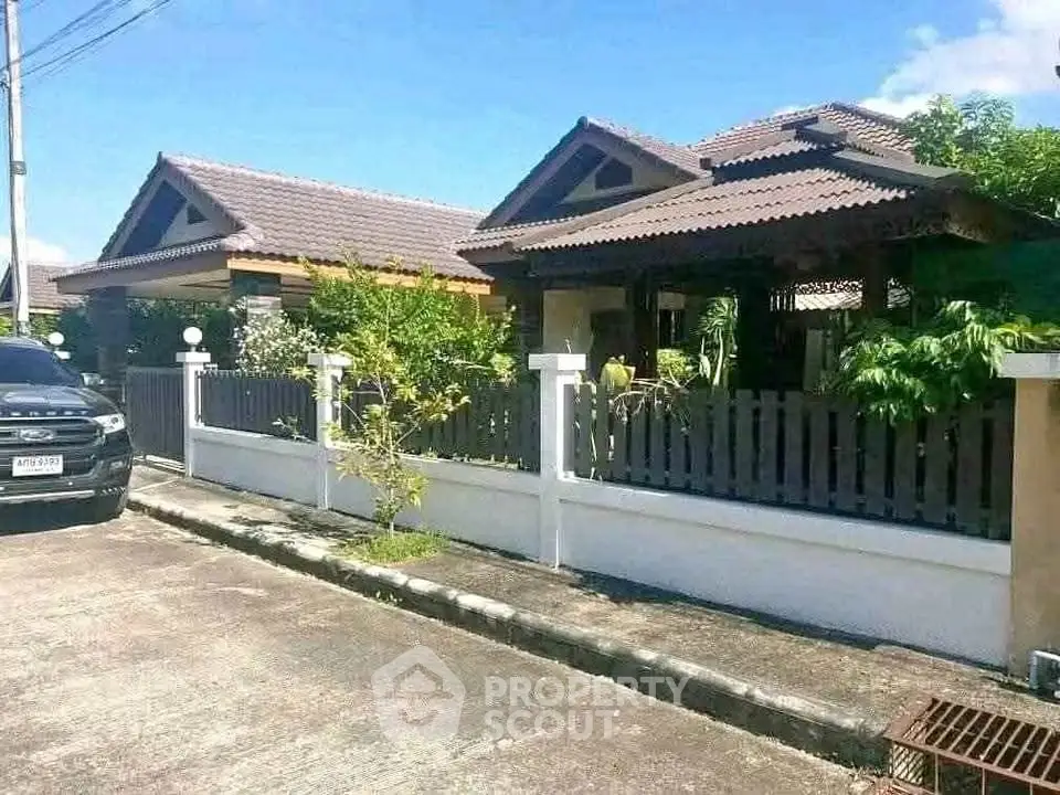 Charming suburban homes with traditional roofing and lush greenery in a peaceful neighborhood.