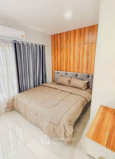 Cozy bedroom with modern design and wooden accents, perfect for relaxation.