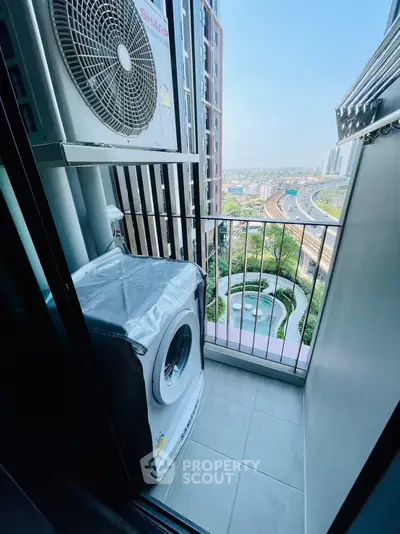 Charming balcony with city view and laundry setup, perfect for urban living convenience.
