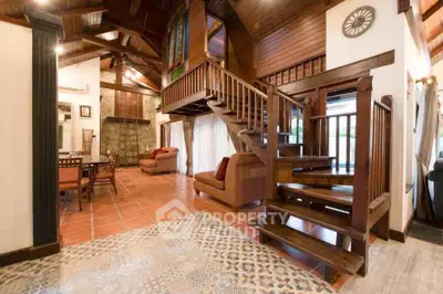 Charming rustic living room with wooden staircase and high ceilings