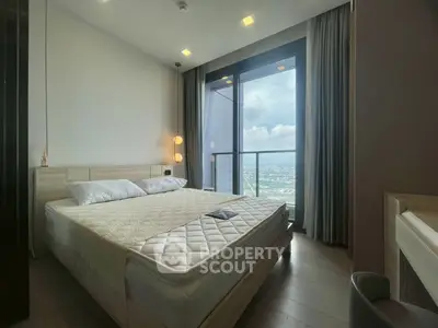 Modern bedroom with large window offering stunning city view, featuring cozy bed and elegant decor.