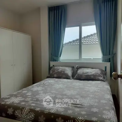 Cozy bedroom with large window and stylish curtains, featuring a comfortable bed and spacious wardrobe.