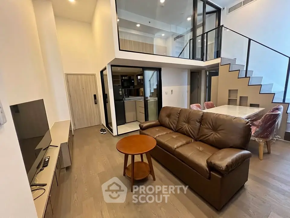 Modern duplex living room with high ceilings and stylish furniture