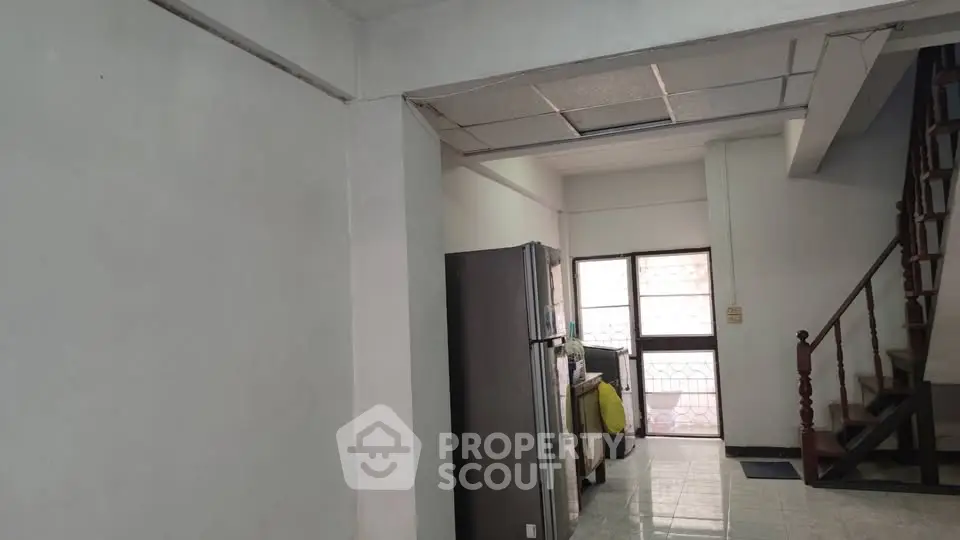 Spacious interior with modern kitchen and staircase, ideal for family living.