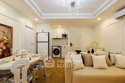 Chic living room with elegant decor, modern kitchen appliances, and cozy dining area in a stylish apartment.