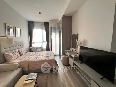 Modern bedroom with stylish decor and natural light, featuring a cozy bed and sleek furniture.