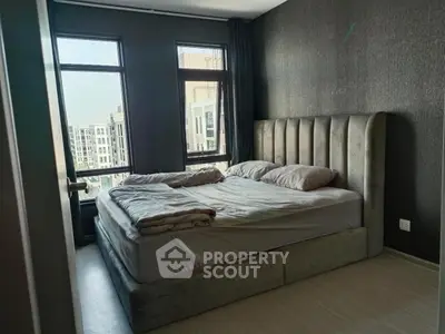 Modern bedroom with large windows and stylish bed in urban apartment