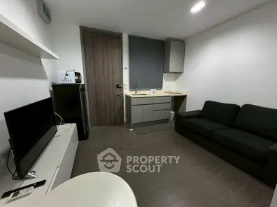 Modern studio apartment with sleek kitchen and cozy living area