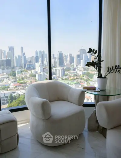 Luxurious living room with stunning city skyline view and elegant white armchair.