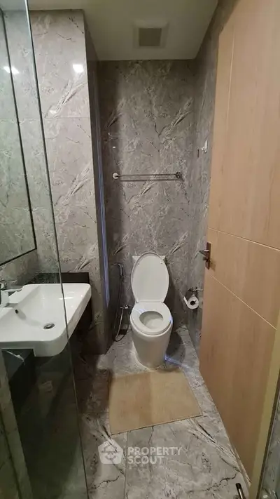 Modern bathroom with marble tiles and sleek fixtures