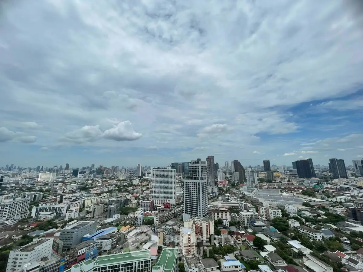 Stunning cityscape view from high-rise building showcasing urban skyline and expansive sky.